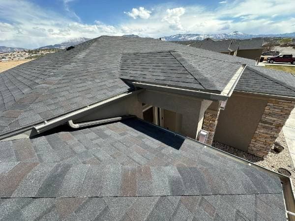 New architectural shingle roof with Southern Utah mountains behind it