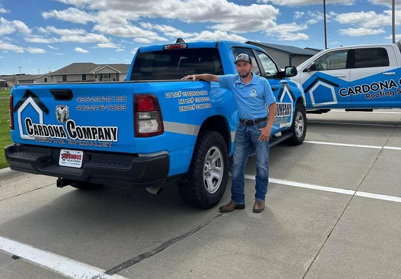 Gustavo Cardona, Owner & Lead Roofer at Cardona Company, beside a branded Cardona Company truck